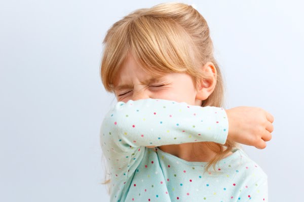 girl-sneezing-into-elbow